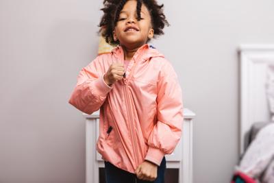 little girl getting ready for school