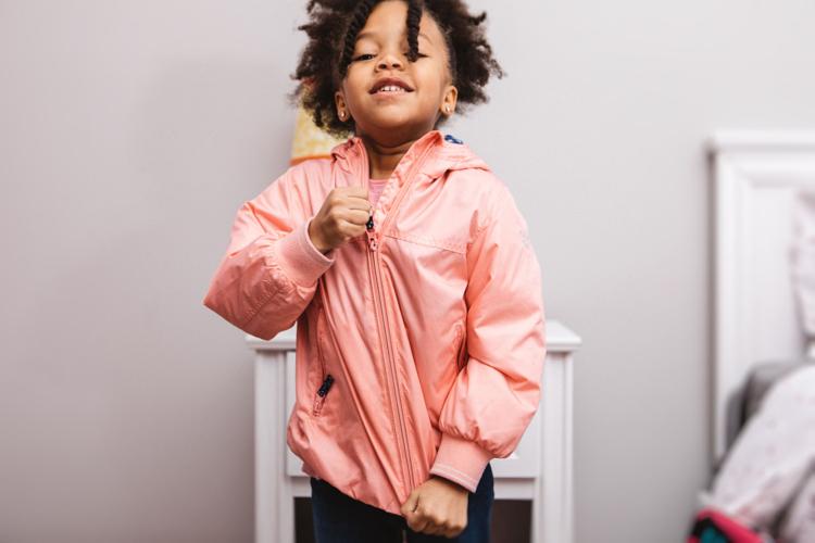 little girl getting ready for school