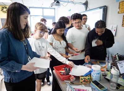 FMS Teacher Christy Overall guides 8th-grade students during a lesson on poetry.