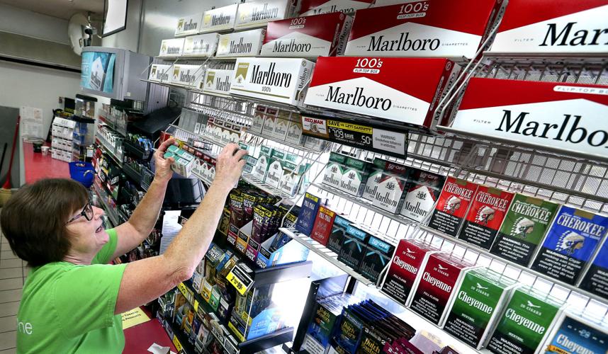 what is a cigarette mom Mother in her 20's smoking a cigarette holding and her baby in her arms  Stock Photo