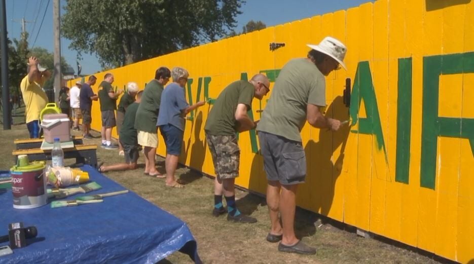 Family and friends honor Packers fan by painting new slogan on historical  fence