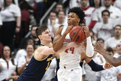 No. 1 Louisville tops No. 4 Michigan 58-43 in Big Ten/ACC