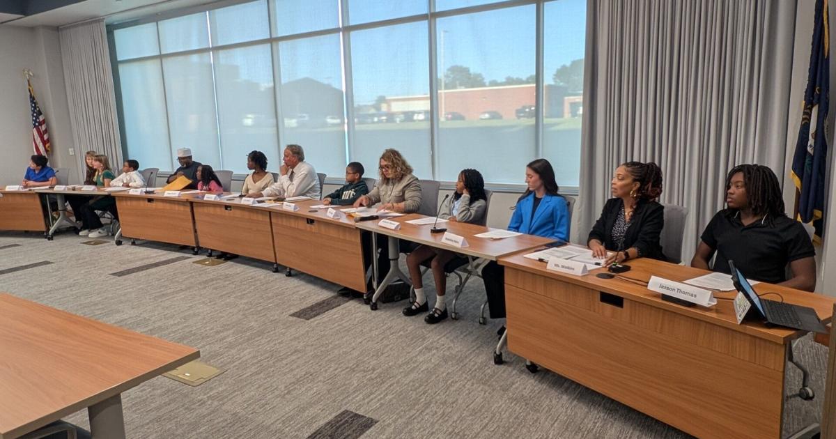 TaLajha Cork of Paducah Tilghman high school leads a Paducah Public Schools board meeting alongside Board Chair Carl LeBuhn on Oct. 19.