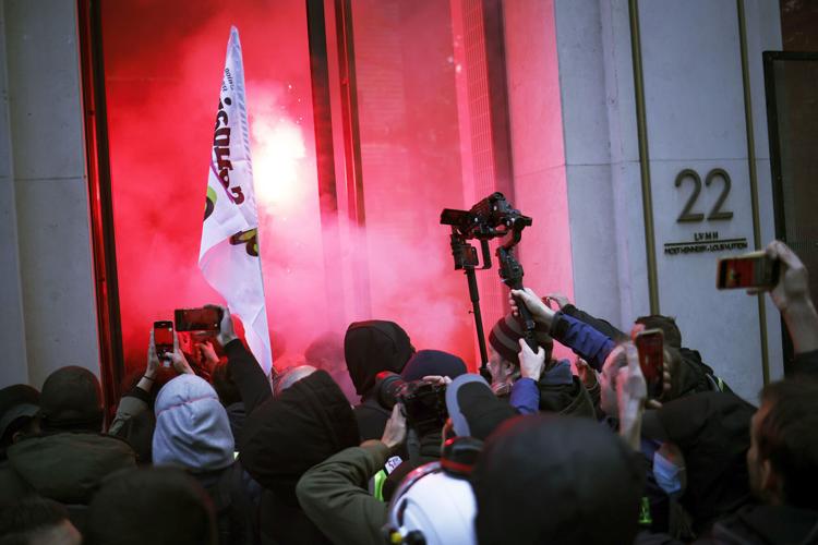 Protesters set off flares inside Louis Vuitton HQ in Paris
