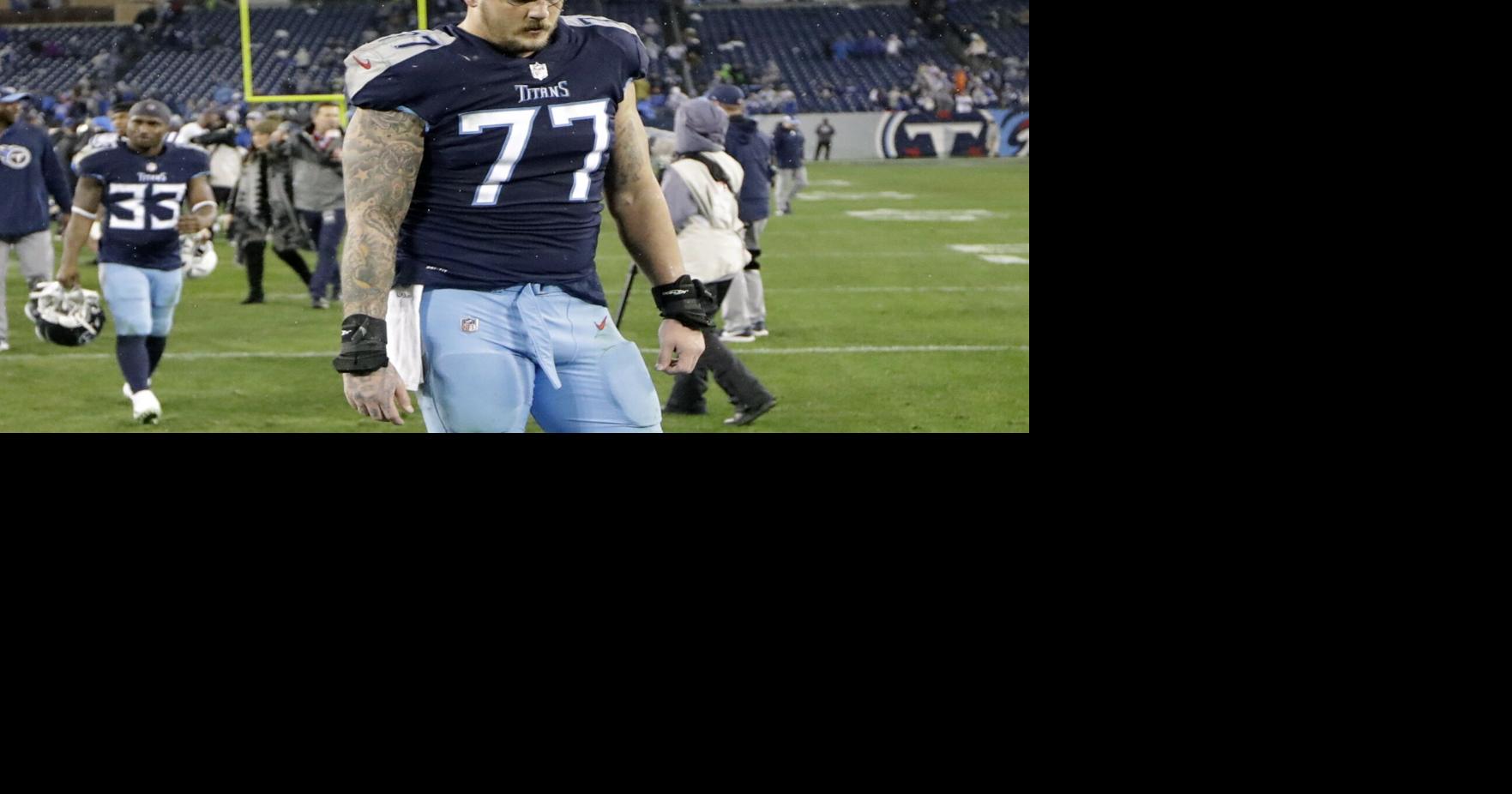 Titans' Taylor Lewan carted off with knee injury vs. Bills