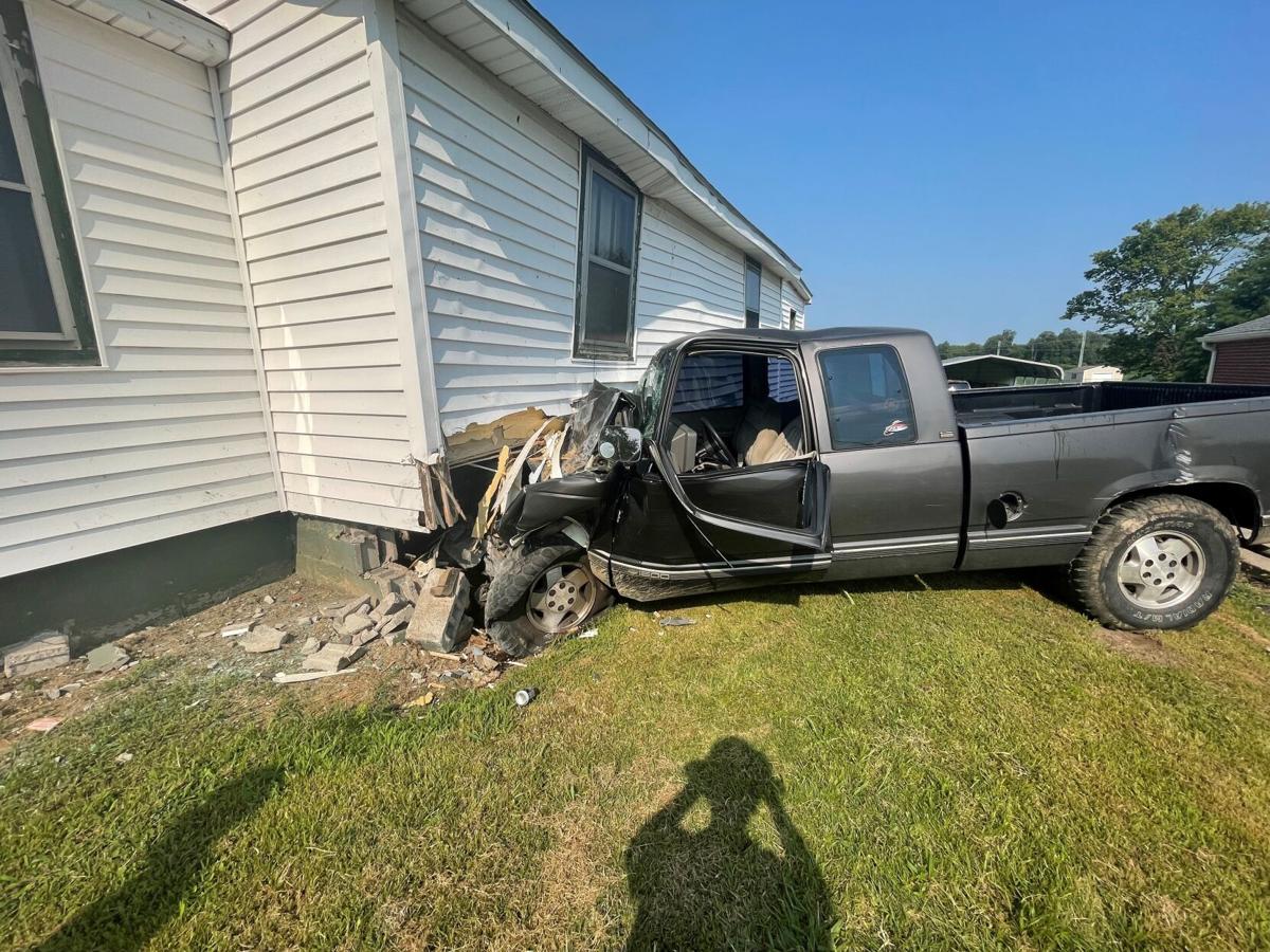 Driver injured, charged with multiple offenses after truck crashes into