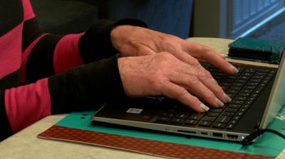 Scam victim Marjorie typing