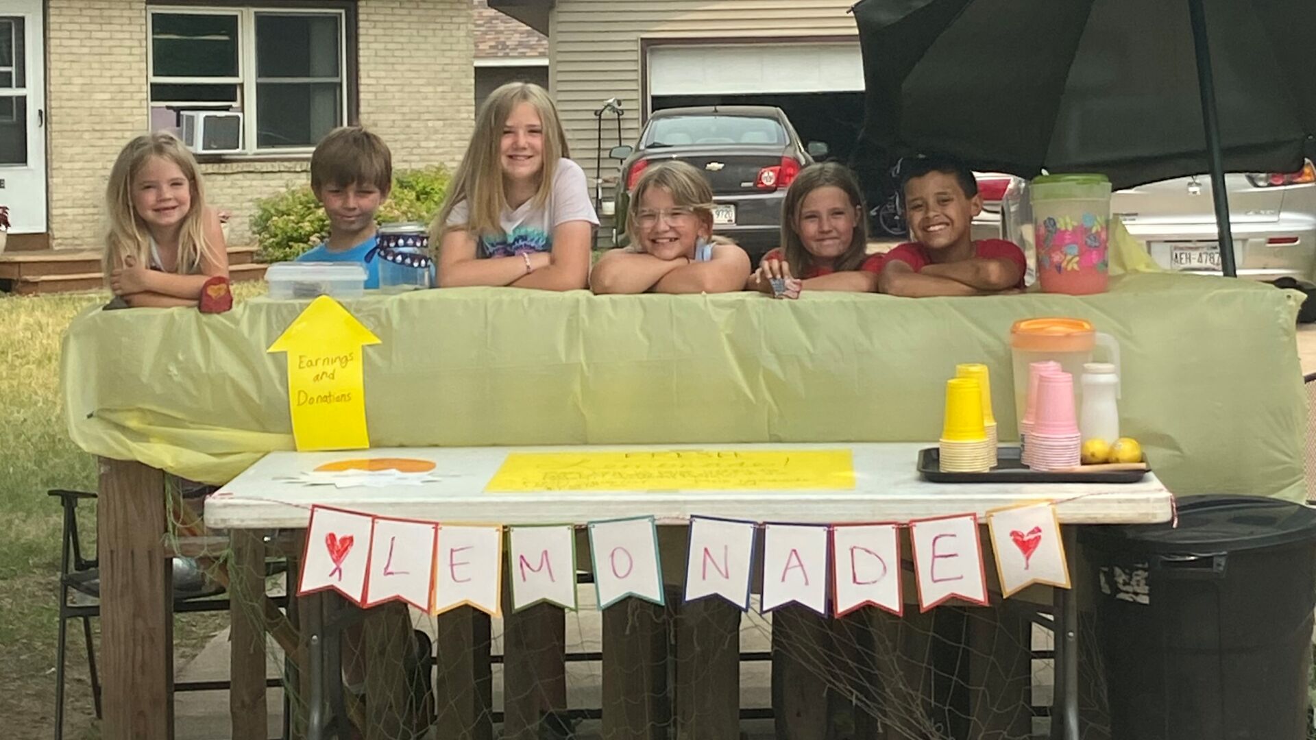 Kids raising money with lemonade stand after friend hurt