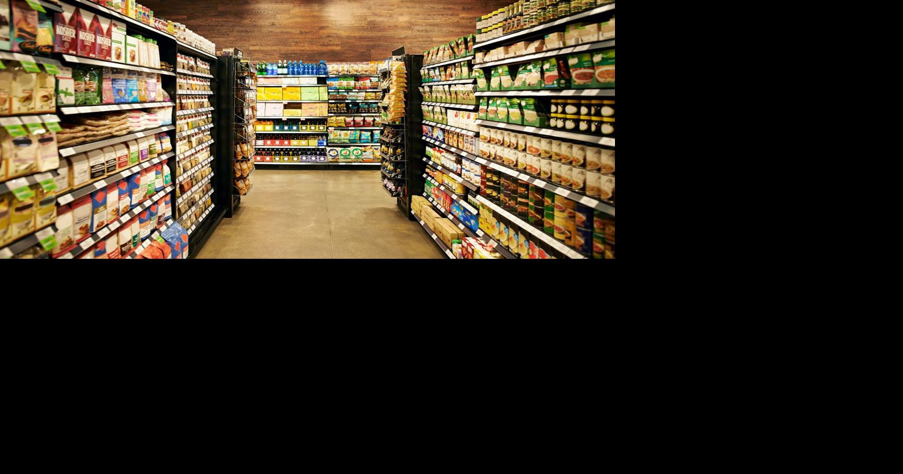 Person examining nutrition facts and ingredient list on packaged food