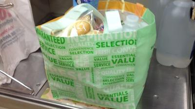 A reusable grocery bag at the checkout counter., Photo Date: Dec 18, 2013