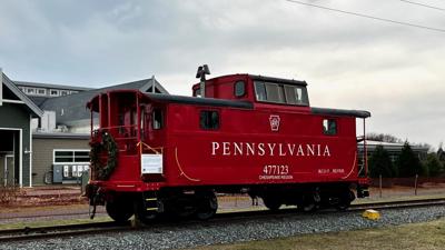 The white lettering stands out against the red of the caboose and is the final renovation taking place on the exterior. Courtesy Lewes Junction Railroad and Bridge Association.