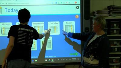 Life skills teacher helping students with disabilities stay ...