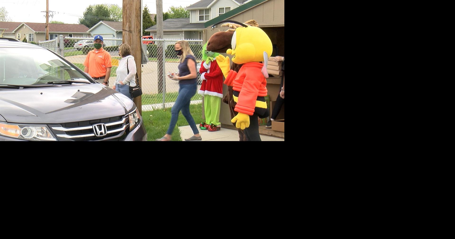 Characters help Belvidere Family YMCA hand out food Positive Local