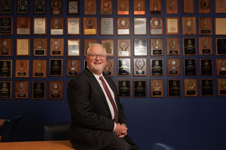 Dr Jonah Rice with Forensic Falcons Awards Wall.jpg