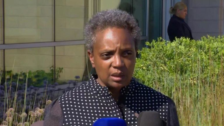 Mayor Lori Lightfoot walks out with Chicago Chief Marketing