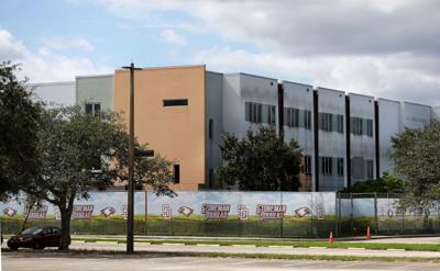 ‘A symbol of failure’: Demolition of Parkland high school massacre site begins as families of the victims look on