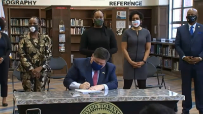 Prtizker signing equity and education act