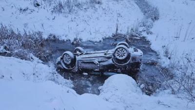 Hero rescues teen brothers from flipped car in water-filled ditch