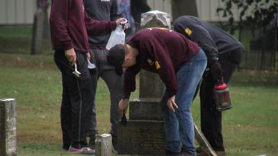 Students clean up a cemetery in Carbondale