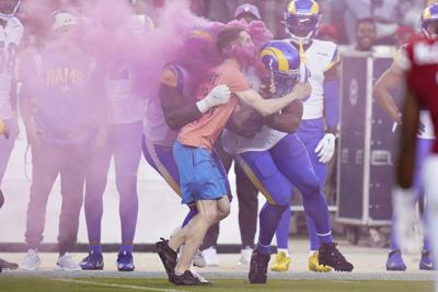 Protester tackled by LA Rams linebacker Bobby Wagner as he ran onto field