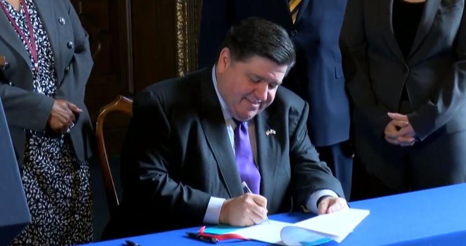 pritzker signs pension bill.png