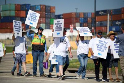 Striking port workers to return to work Friday as negotiators reach an agreement on wages