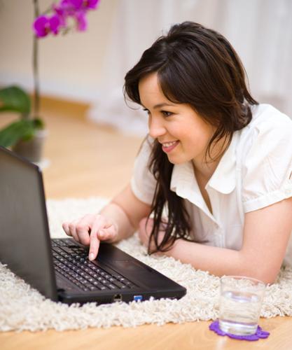Young woman is playing on laptop