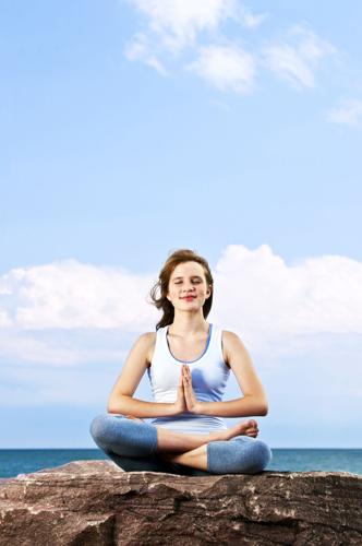 Young girl meditating outdoors
