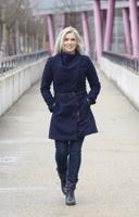 Woman in a stylish blue outfit walking in town