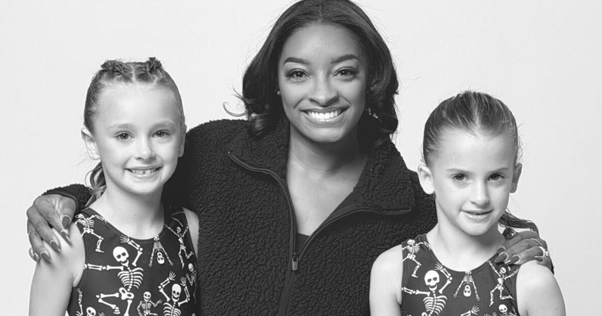 Cross Lanes gymnasts model with Olympic legend Simone Biles