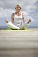 Senior woman doing yoga exercises