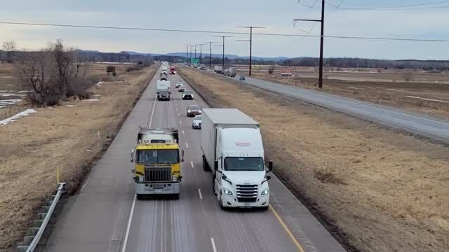 Driver Stunned by 18-Wheeler Convoy Flanked by Trucks and Helicopters on  Highway