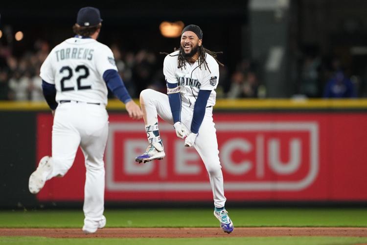 Seattle Mariners' J.P. Crawford holds a trident after hitting a