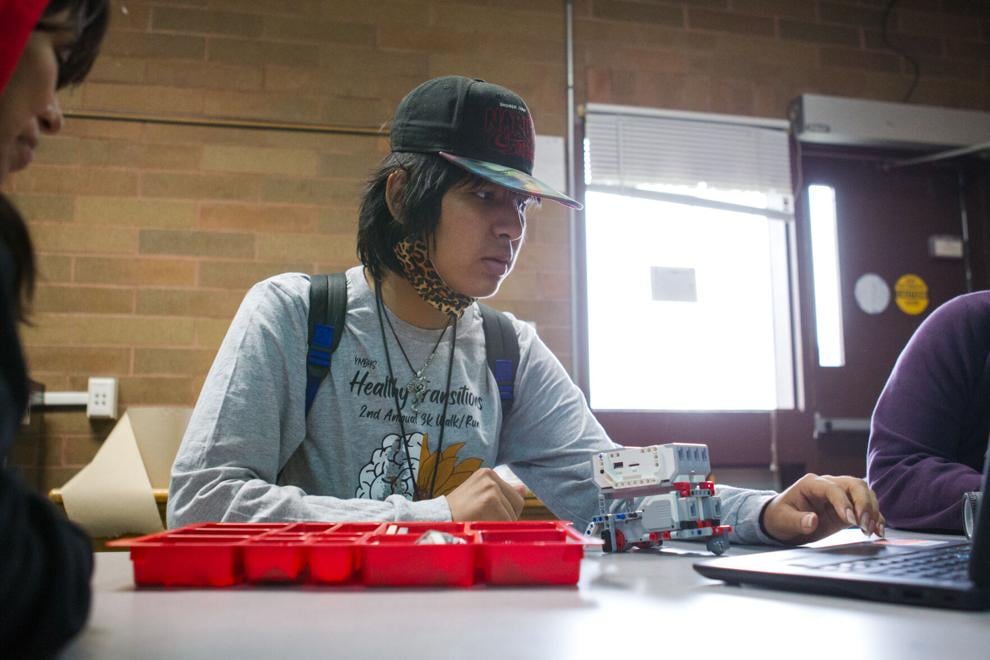 Kenneth Jim works with his classmates in a robotics class at White Swan High School