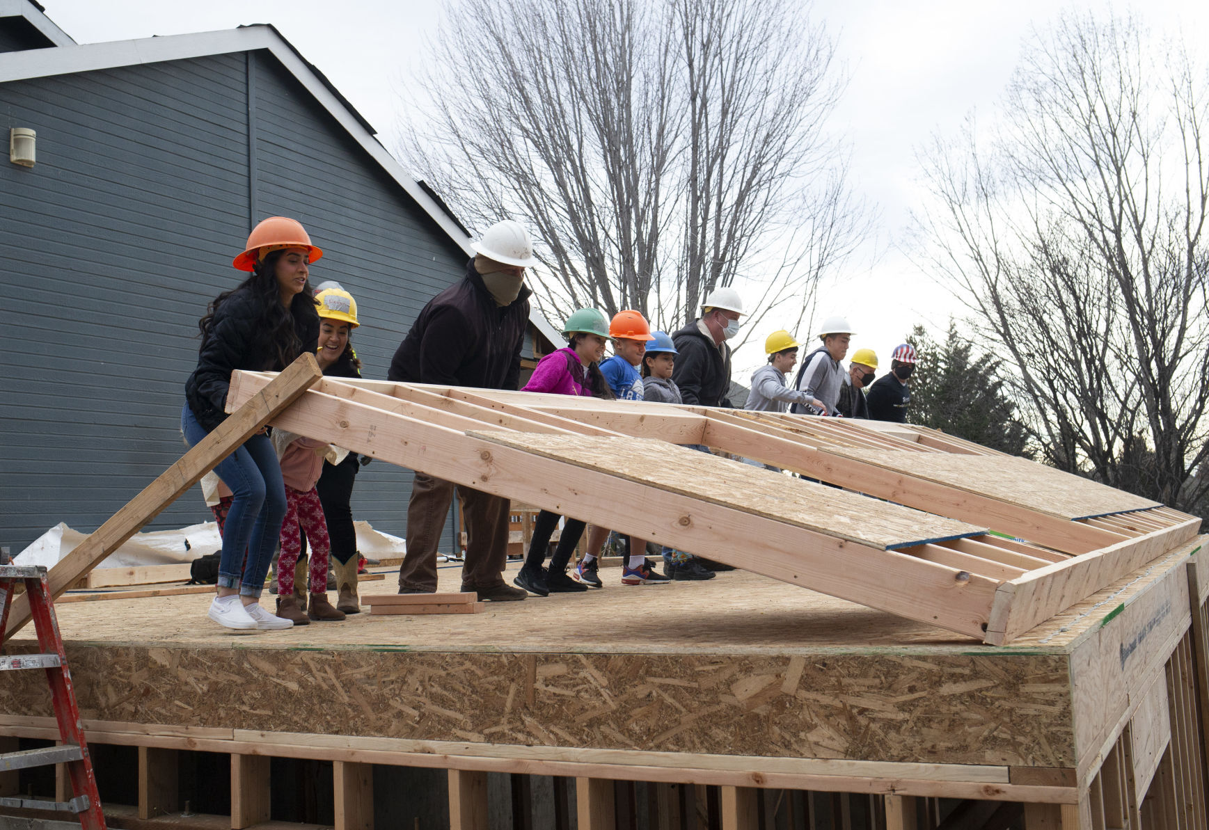Family members help 'raise the wall' in Zillah in celebration of Habitat project - Vimarsana News