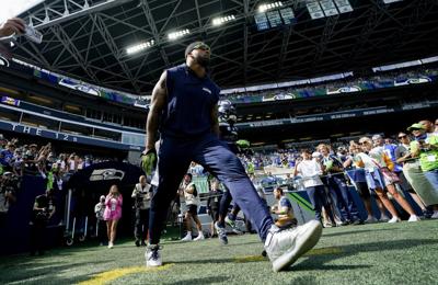 Seattle Seahawks tackle Charles Cross (67) warms up before playing against  the Los Angeles Rams in