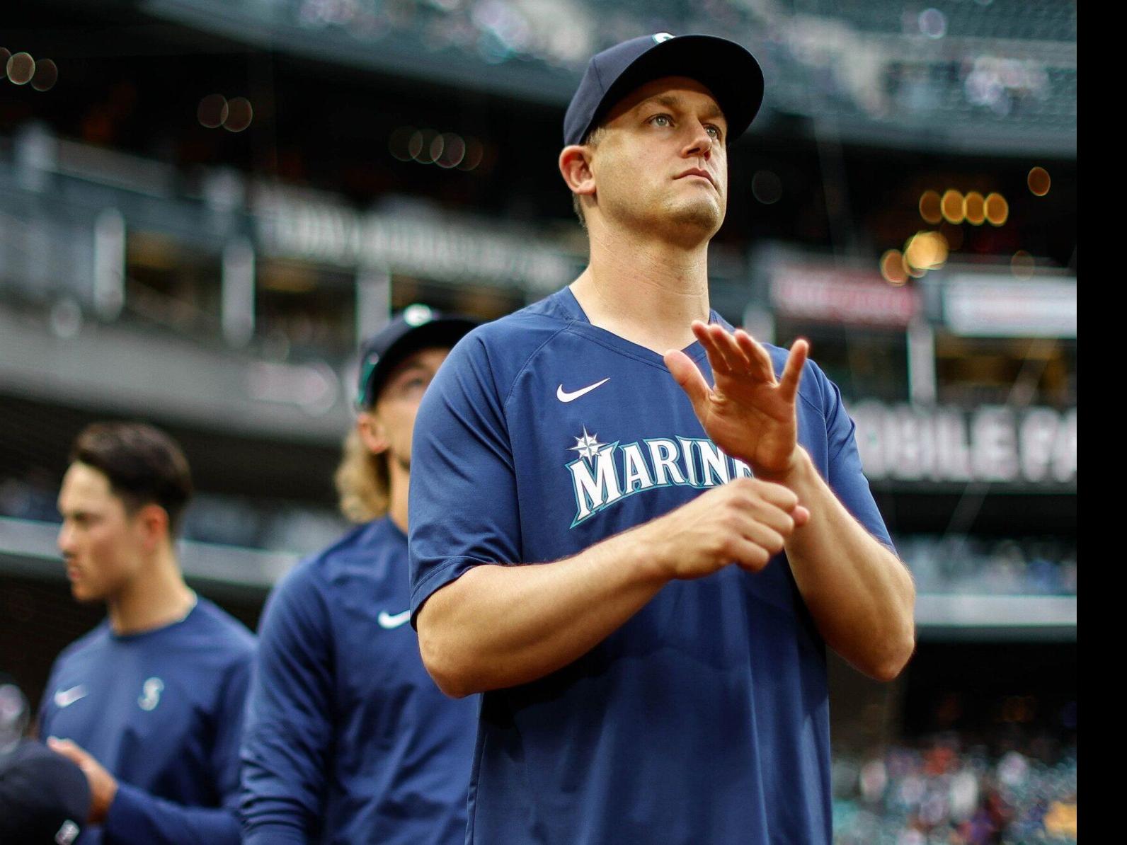 Mariners pitcher Paul Sewald reacts to Blue Jays merchandise being