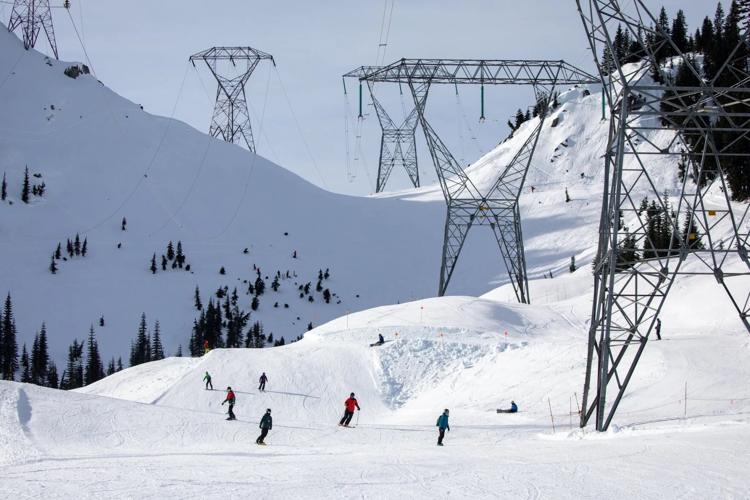 Skiers and snowboarders ride down the back side of Stevens Pass
