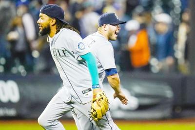 Ty France of the Seattle Mariners celebrates scoring a run with
