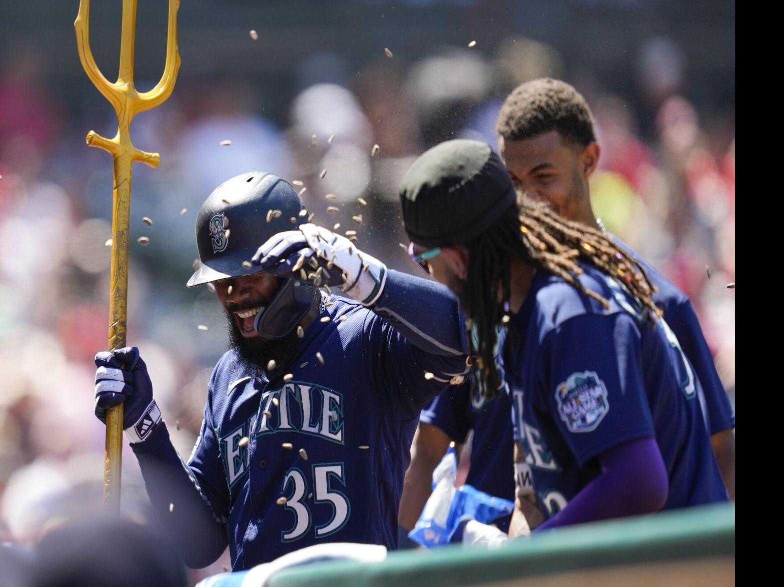 Seattle Mariners Vs. New York Mets Seattle Mariners Teoscar Hernandez 35 is  handed the trident