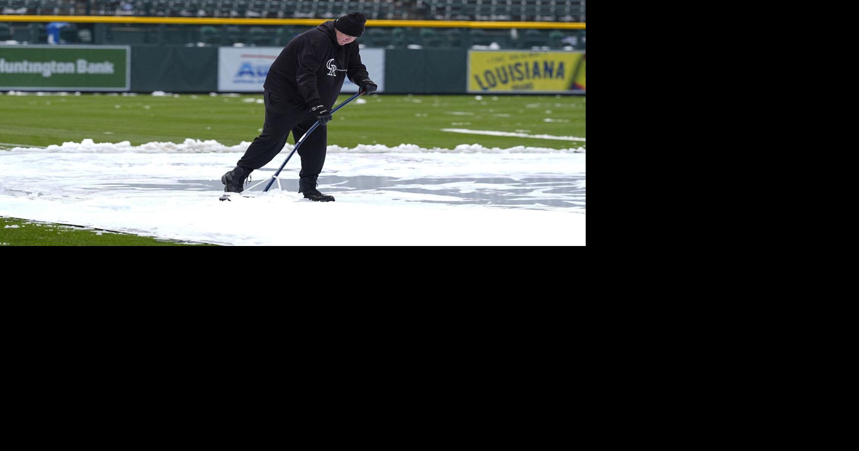 Snow blankets Coors Field before chilly MarinersRockies game in Denver