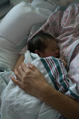 Newborn being held