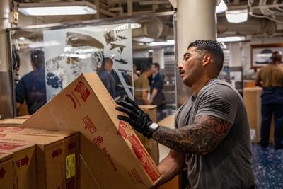 Greensboro Native handles supplies during underway replenishment aboard U.S. Navy warship