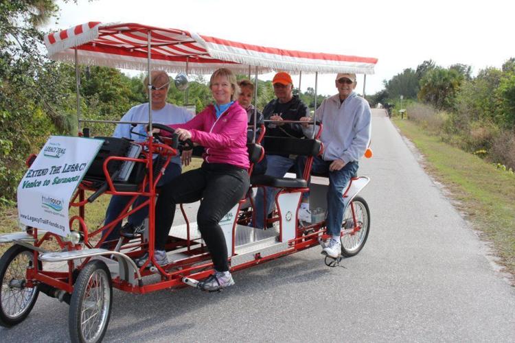 Ride the surrey Experience The Legacy Trail in a fourwheeled canopy