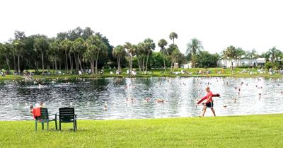 A lifeguard monitors the crowd at Warm Mineral Springs