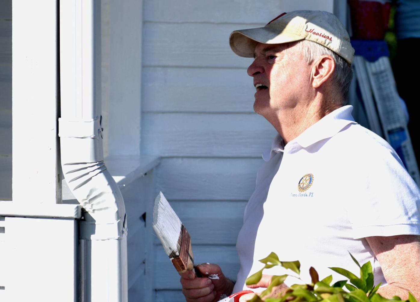 Volunteers paint historic Cigar Cottage at History Park