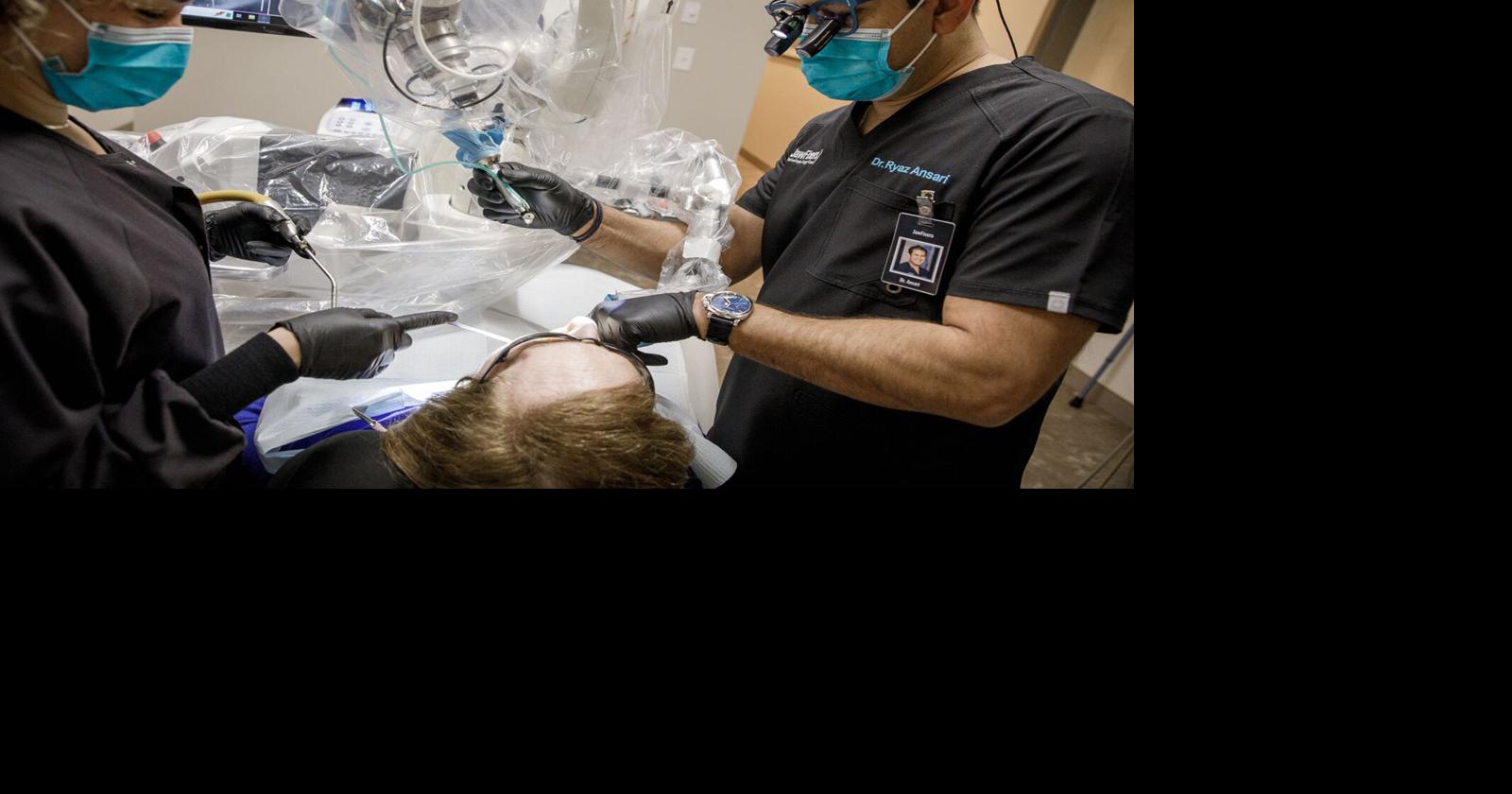 Oral surgeon has help when drilling implants. Meet his robotic