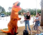 Kids with the dinosaur at the event