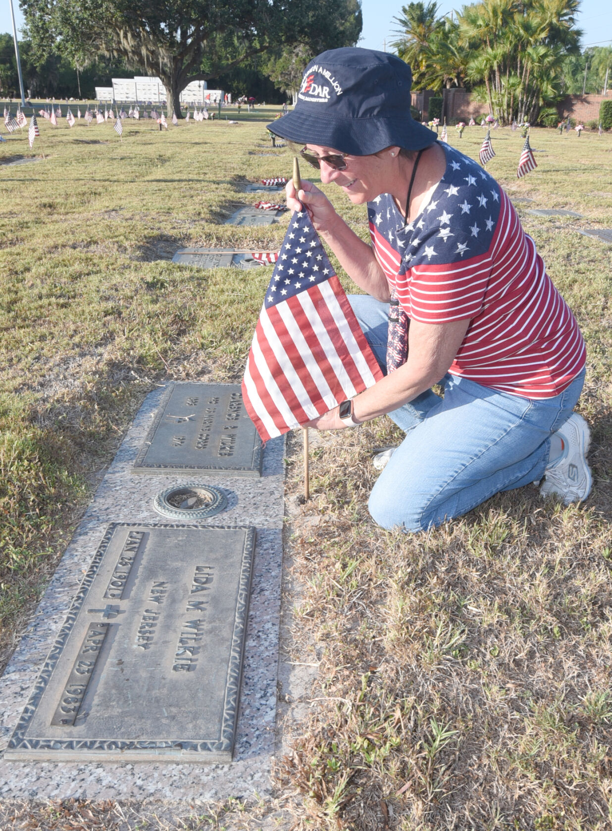 Volunteers place flags at gravesites for Memorial Day | Multimedia ...
