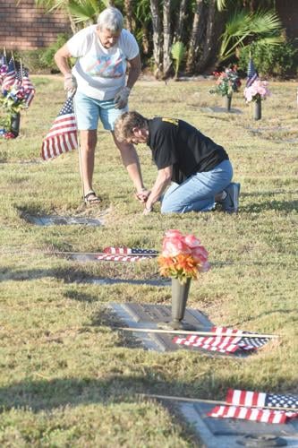 Volunteers place flags at gravesites for Memorial Day | Multimedia ...